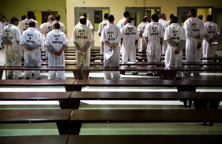 FILE - In this Dec. 1, 2015, file photo prisoners stand while being processed for intake at the Georgia Diagnostic and Classification Prison in Jackson, Ga. (AP Photo/David Goldman)