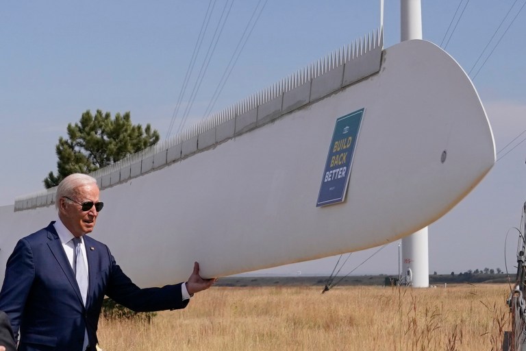 President Joe Biden holds onto a wind turbine blade during a tour at the Flatirons campus of the National Renewable Energy Laboratory, Tuesday, Sept. 14, 2021, in Arvanda, Colorado.