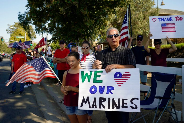 Well-wishers line the main thoroughfare during the funeral procession for United States Marine, Lance Cpl. Kareem M. Nikoui, Friday, Sept. 17, 2021, in Norco, California.