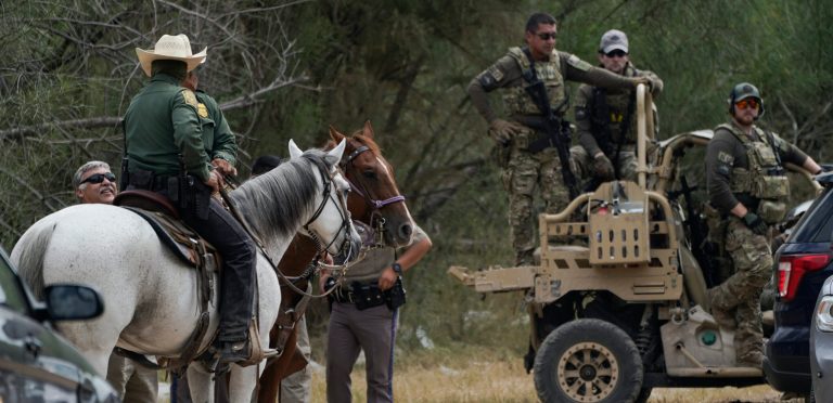 Officials are seen on horseback and an off terrain vehicle adjacent to the Texas-Mexico border, Tuesday, Sept. 21, 2021, in Del Rio, Texas. The U.S. is flying Haitians camped in a Texas border town back to their homeland and blocking others from crossing the border from Mexico.