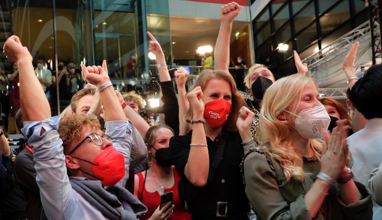 Supporters react after German parliament election at the Social Democratic Party, SPD, headquarters in Berlin, Sunday, Sept. 26, 2021.