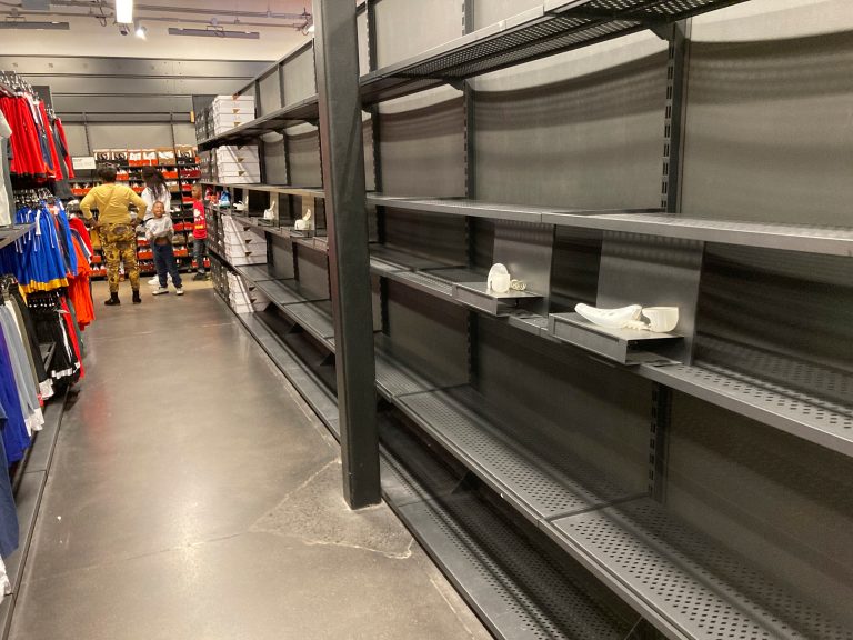 For BizâShelves sit empty of shoes in a Nike outlet store Tuesday, Oct. 5, 2021, in Castle Rock, Colo. (AP Photo/David Zalubowski)