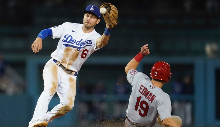 St. Louis Cardinals' Tommy Edman (19) steals second base ahead of a throw to Los Angeles Dodgers second baseman Trea Turner (6) during the ninth inning of a National League Wild Card playoff baseball game Wednesday, Oct. 6, 2021, in Los Angeles.