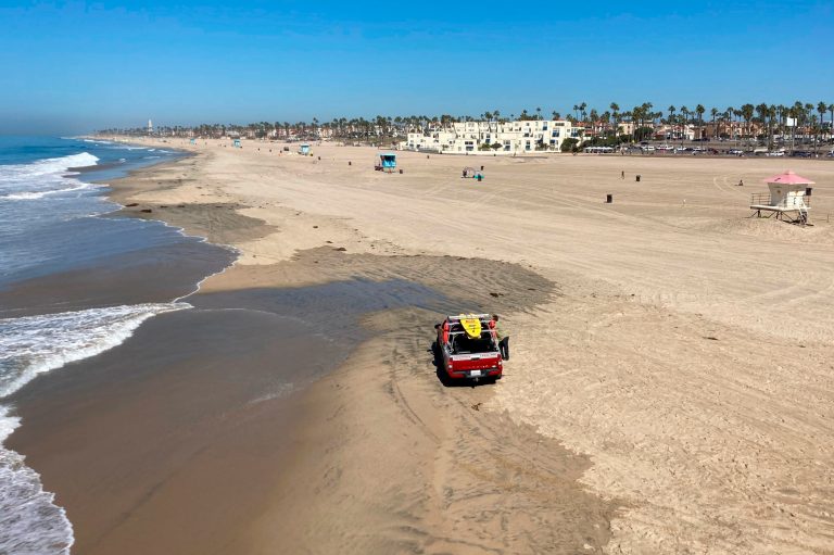 Surf City USA in California reopens beach after oil spill