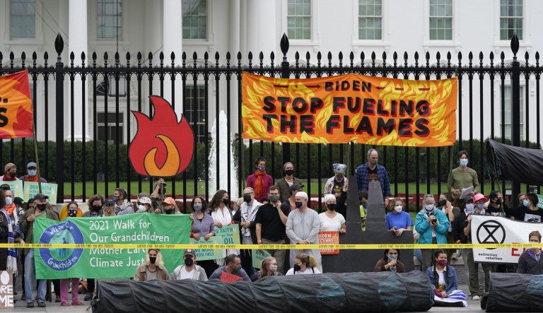 Protesters gather to call on the Biden administration to do more to combat climate change and ban fossil fuels outside the White House in Washington, Tuesday, Oct. 12, 2021.