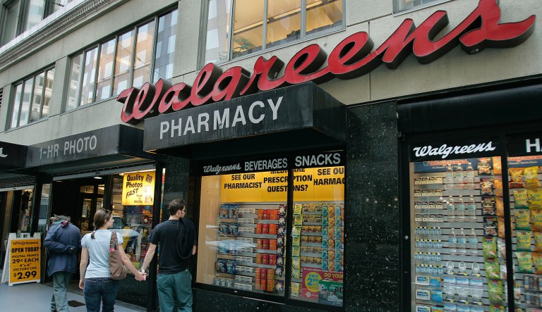 In this June 26, 2006 file photo, window shoppers look at a Walgreens storefront in San Francisco. Walgreens says it will close five more stores in San Francisco next month because of organized retail theft. The drugstore chain has closed at least 10 stores in the city since the start of 2019.