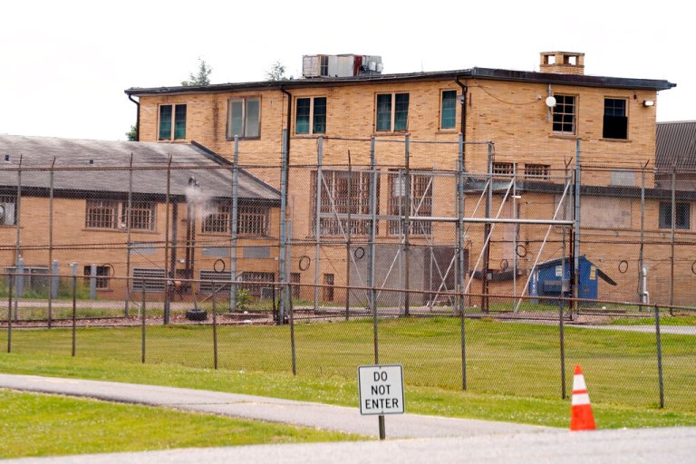 FILE â In this June 8, 2021 file photo. a high fence surrounds buildings on the grounds of the Edna Mahan Correctional Facility for Women in Clinton, N.J. Two inmates are pregnant after allegedly having 