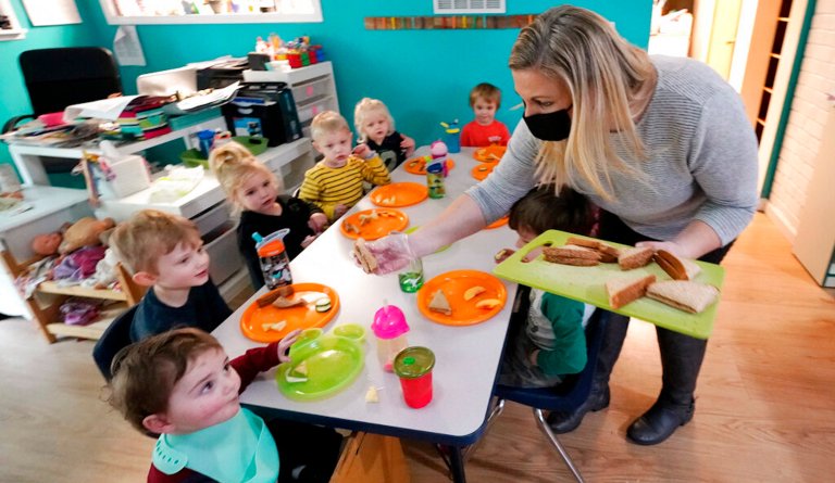 Amy McCoy serves lunch to preschoolers at her Forever Young Daycare facility, Monday, Oct. 25, 2021, in Mountlake Terrace, Wash. Child care centers once operated under the promise that it would always be there when parents have to work. Now, each teacher resignation, coronavirus exposure, and day care center closure reveals an industry on the brink, with wide-reaching implications for an entire economyâs workforce. (AP Photo/Elaine Thompson)