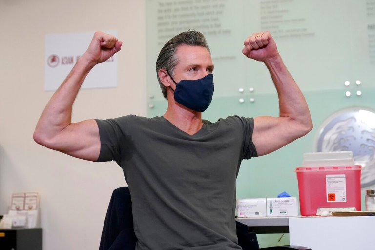 Gov. Gavin Newsom gestures after receiving a Moderna COVID-19 vaccine booster shot at Asian Health Services in Oakland, Calif., on Oct. 27.