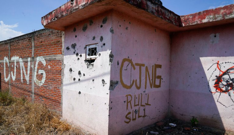 The letters âCJNGâ for the groupâs formal name, Jalisco New Generation Cartel, are scrawled on the facade of an abandoned home, in El Limoncito, in the Michoacan state of Mexico, Saturday, Oct. 30, 2021. The cartel based in Jalisco state is invading neighboring Michoacan, causing thousands of farmers to flee, with some seeking asylum in the United States. 