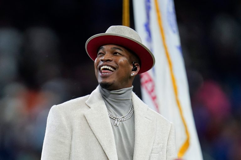 Ne-Yo smiles after singing the national anthem before an NFL football game between the Detroit Lions and Chicago Bears in Detroit, Thursday, Nov. 25, 2021.