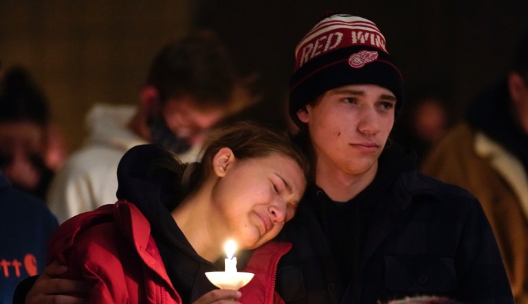 People attending a vigil for the victims of a school shooting embrace at LakePoint Community Church in Oxford, Mich., Tuesday, Nov. 30, 2021. Authorities say a 15-year-old sophomore opened fire at Oxford High School, killing several students and wounding multiple other people, including a teacher.