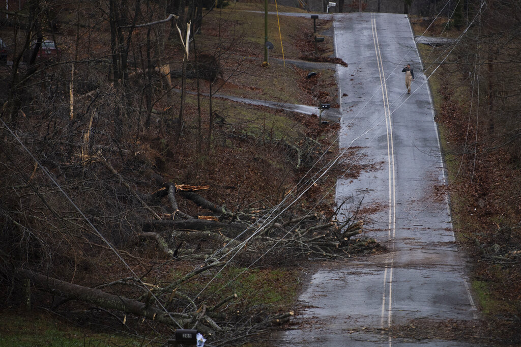 Murrell Road resident Keith Kruse surveys the damage from overnight storms that ripped through his community Saturday in Dickson County, Tennessee.