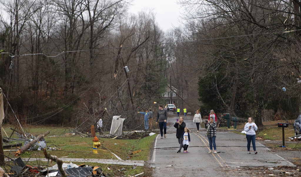 Residents along Murrell Road survey the storm damage Saturday in Dickson County, Tennessee.