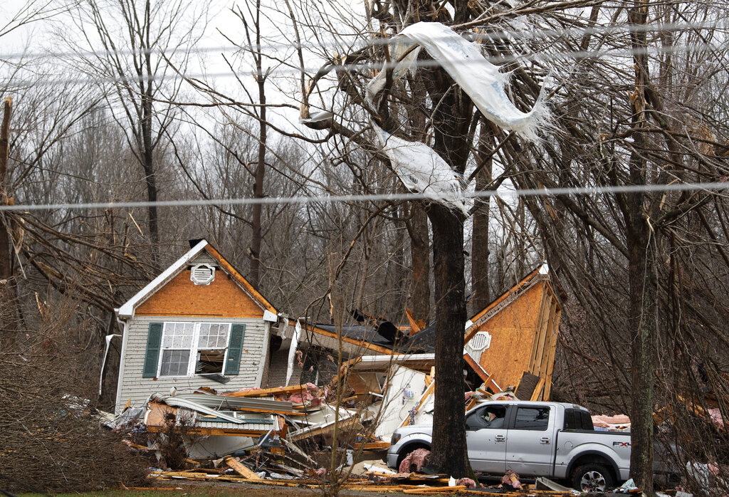 Residents along Murrell Road survey the damage from storms that ripped through their community in Dickson County, Tennessee.