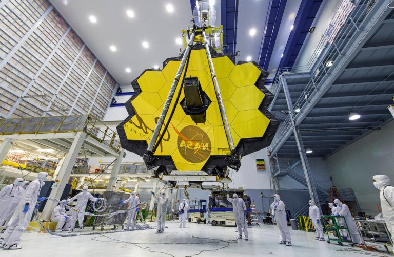 In this April 13, 2017 photo provided by NASA, technicians lift the mirror of the James Webb Space Telescope using a crane at the Goddard Space Flight Center in Greenbelt, Maryland.