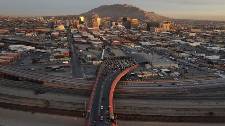 FILE - Cars line up at the Paso del Norte international bridge in Ciudad Juarez, Mexico, below, on the border with El Paso, Texas, top, Nov. 8, 2021. (AP Photo/Christian Chavez, File)