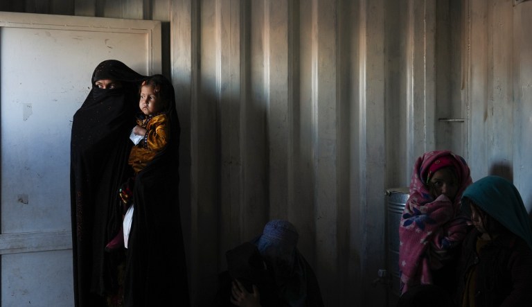 Afghan women wait in the makeshift clinic organized by World Vision in the IDP settlement near Herat, Afghanistan, Thursday, Dec. 16, 2021. Thousands of Afghans displaced by war and drought live in dire conditions in the IDP settlement of mud brick huts near Herat city. The number of Afghans facing acute food shortages has increased 37% since April, the ICRC says, while 3.2 million children under five are expected to suffer from acute malnutrition by the end of the year.                                                                  