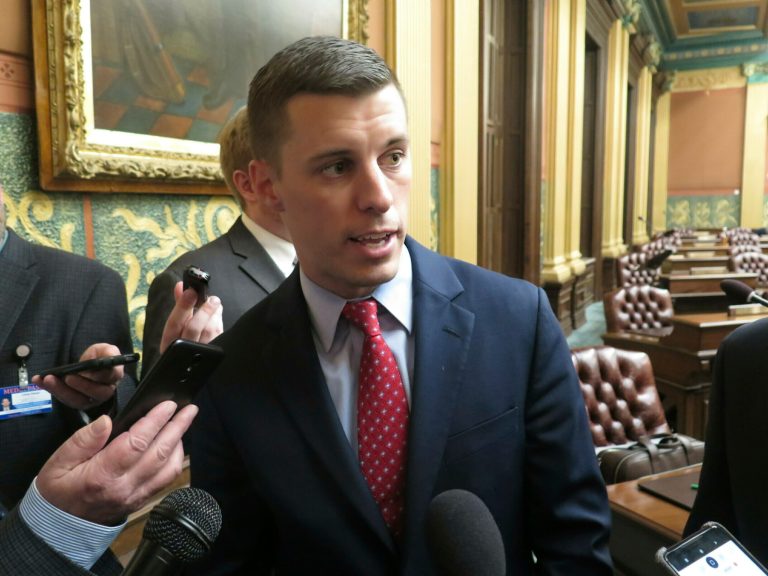 Michigan House Speaker Lee Chatfield speaks with reporters following the House's approval of a bill that would cut auto insurance premiums on May 9, 2019, in the Capitol in Lansing, Michigan.