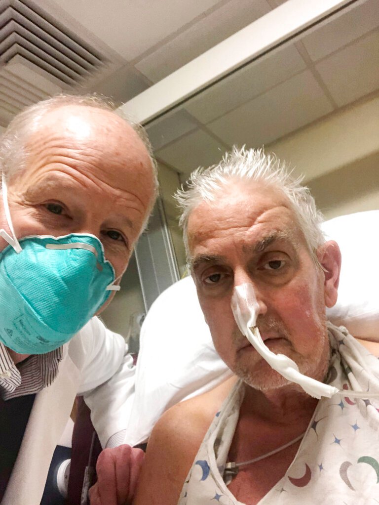 In this photo provided by the University of Maryland School of Medicine, Dr. Bartley Griffith takes a selfie photo with patient David Bennett in Baltimore in January 2022. In a medical first, doctors transplanted a pig heart into Bennett in a last-ditch effort to save his life and the hospital said Monday, Jan. 10, 2022 that he's doing well three days after the highly experimental surgery. 