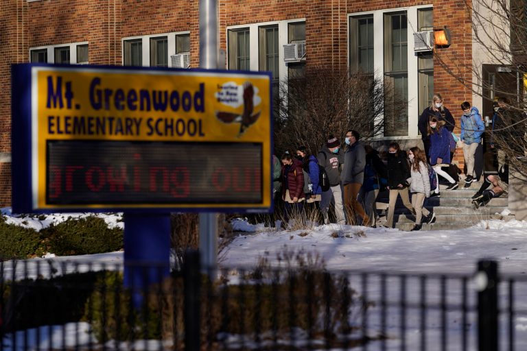 Students at the Mt. Greenwood Elementary School in Chicago depart after a full day of classes Monday, Jan. 10, 2022. 