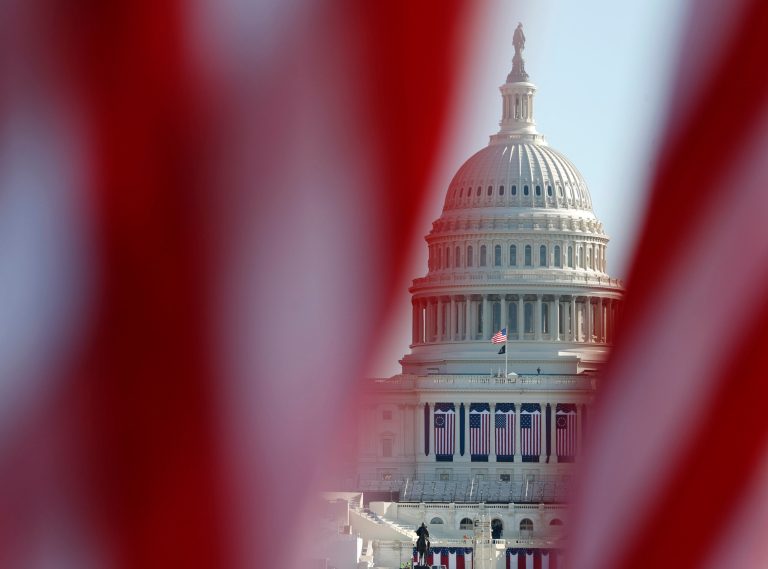 The Capitol is seen through a display of flags on the National Mall, one day after the inauguration of President Joe Biden, on Jan. 21, 2021, in Washington.