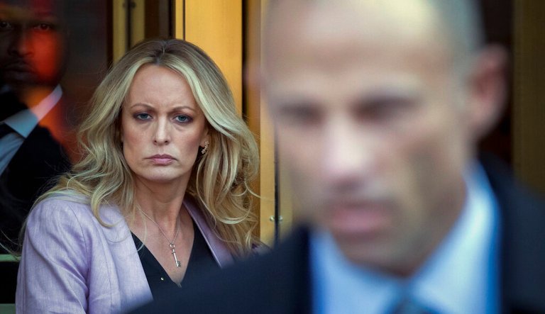 Adult film actress Stormy Daniels, left, follows her attorney Michael Avenatti, right, as she leaves federal court, Monday, April 16, 2018, in New York. 