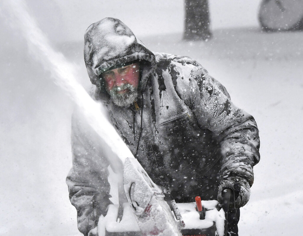 Dale McElwee clears his North Attleboro, Massachusetts, property of snow on Saturday.
