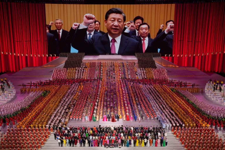 Chinese President Xi Jinping is seen leading other top officials pledging their vows to the party on screen during a gala show ahead of the 100th anniversary of the founding of the Chinese Communist Party in Beijing.