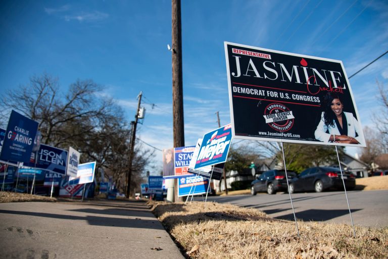 A sign for Jasmine Crockett is posted outside the Lakewood Branch Library as voters trickle in to participate in the Texas primary election in Dallas on Tuesday, March 1, 2022. 