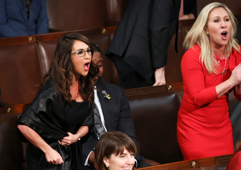 Rep. Lauren Boebert, R-Colo., left, and Rep. Marjorie Taylor Greene, R-Ga., right, scream 