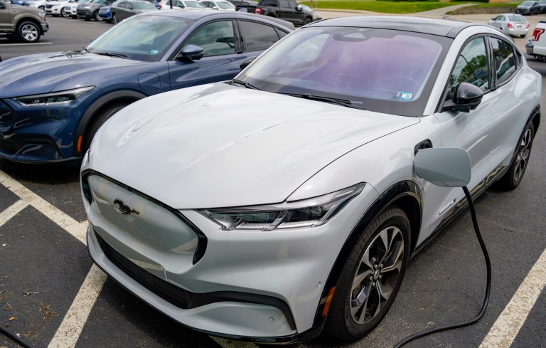 In this photo made on Thursday, May 6, 2021, a pair of 2021 Ford Mustang Mach E are seen at a Ford dealer in Wexford, Pa.   (AP Photo/Keith Srakocic)
