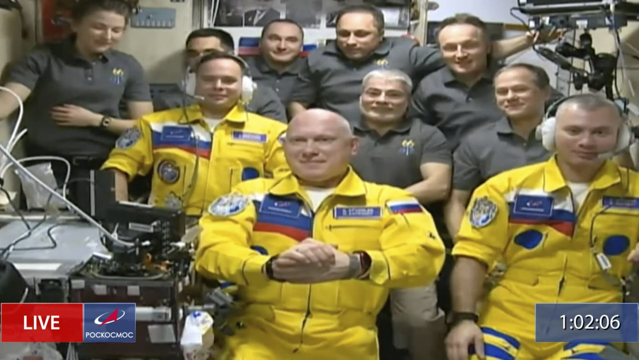 Russian cosmonauts don Ukrainian flag colors as they board space station