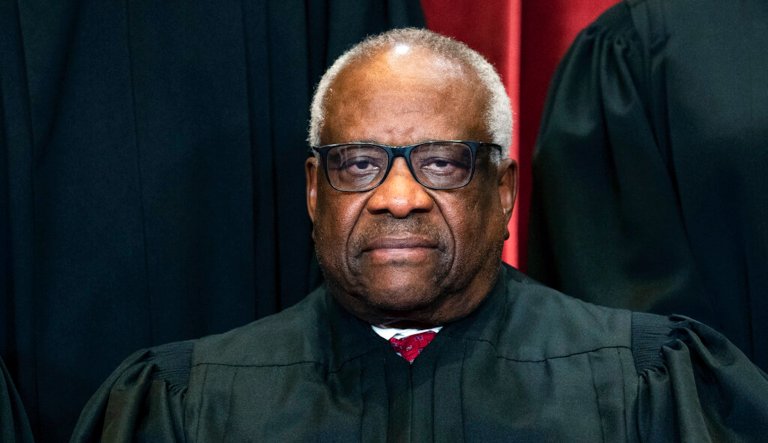 Justice Clarence Thomas sits during a group photo at the Supreme Court in Washington on Friday, April 23, 2021.