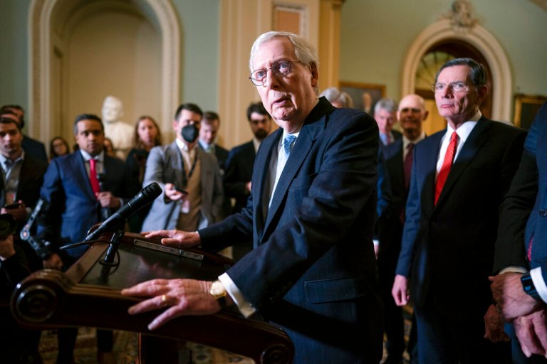 Senate Minority Leader Mitch McConnell, joined at right by Sen. John Barrasso, speaks with reporters about President Joe Biden's proposed $5.8 trillion budget at the Capitol in Washington on March 29, 2022. 