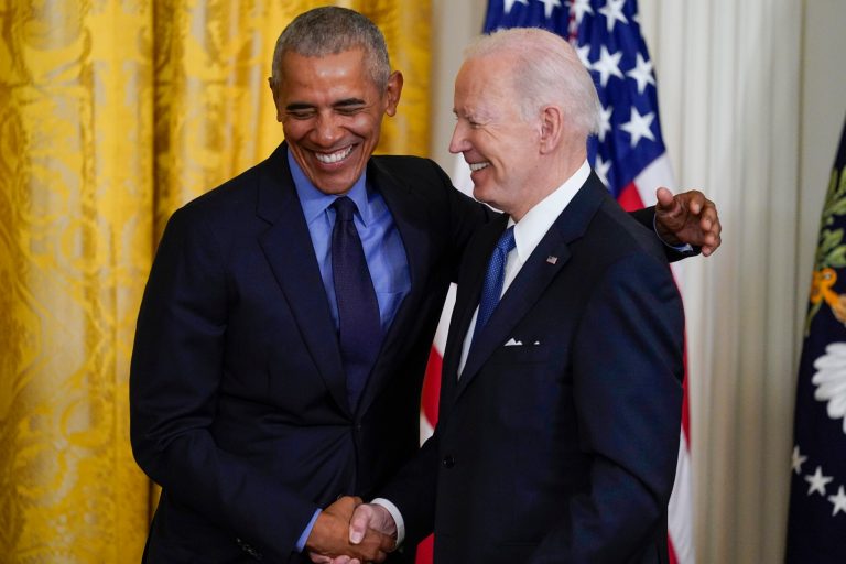 President Joe Biden and former President Barack Obama shake hands onstage during an event about the Affordable Care Act, in the East Room of the White House in Washington, Tuesday, April 5, 2022. 