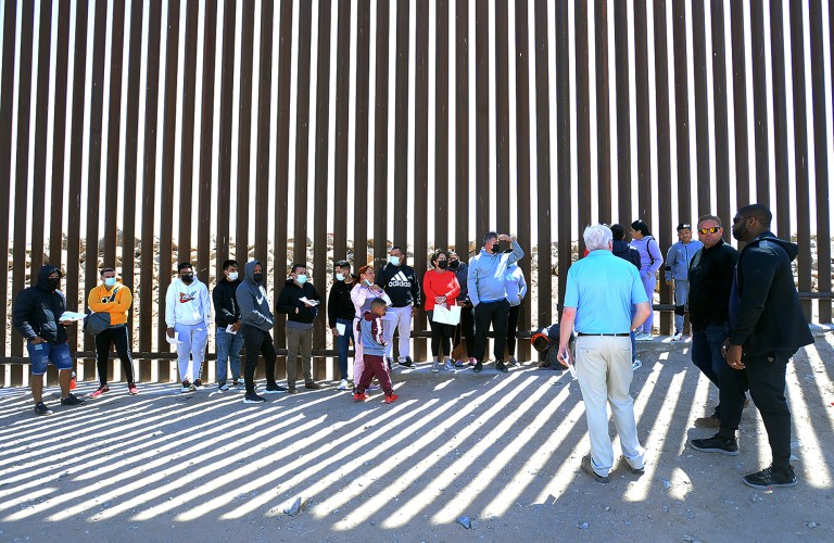 Buy these photos at YumaSun.com
United States Congressman Byron Donalds (R-Fla.) (right), Yuma County Board of Supervisors member Jonathan Lines (second from right) and U.S. Congressman Pete Sessions (R-Texas) (third from right in foreground) meet a group of undocumented immigrants Tuesday morning at the border fence between the United States and Mexico near Morelos Dam.
Photo by Randy Hoeft/Yuma Sun