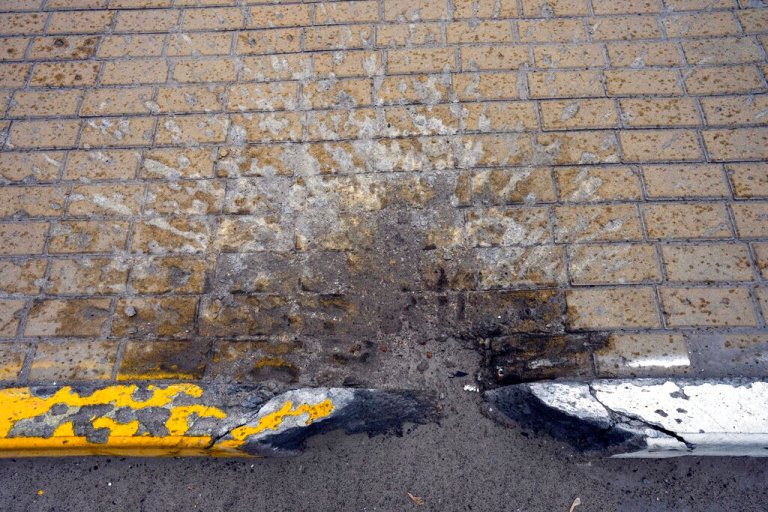 The mark of a shell is seen on a street in Irpin, in the outskirts of Kyiv, Ukraine, Wednesday , April 13, 2022.