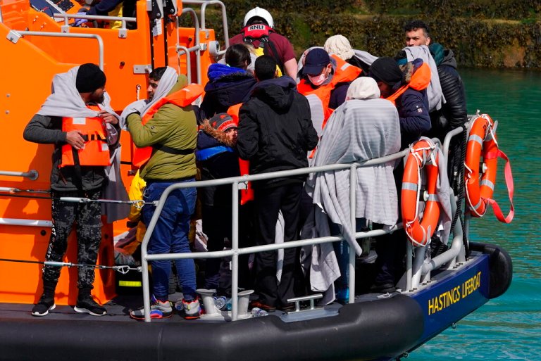 A group of people thought to be migrants are brought in to Dover, Kent, England, by the RNLI, following a small boat incident in the Channel, Thursday April 14, 2022. Britain's Conservative government has struck a deal with Rwanda to send some asylum-seekers thousands of miles away to the East African country. Opposition politicians and refugee groups are condemning the plan as unworkable, inhumane and a waste of public money. 