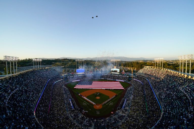 Planes fly over Dodger Stadium as the national anthem is sung before a baseball game between the Cincinnati Reds and the Los Angeles Dodgers in Los Angeles, Thursday, April 14, 2022. Stadium concession workers could go on strike in advance of next weekâs All-Star Game, the union representing those workers said Monday. (AP Photo/Ashley Landis)