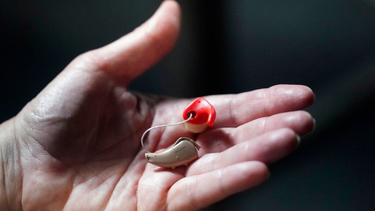 Chelle Wyatt holds her hearing aid Friday, April 15, 2022, in Salt Lake City. 