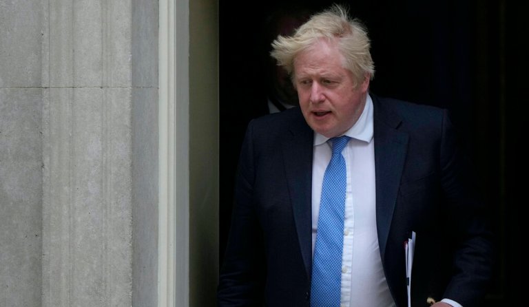 Britain's Prime Minister Boris Johnson leaves for the House of Commons on Tuesday to make a statement about Downing Street parties during the coronavirus lockdowns in London.