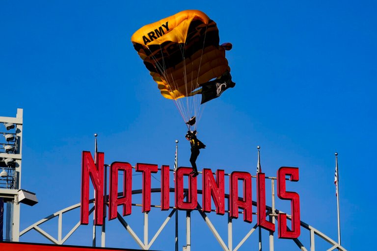 The U.S. Army Parachute Team the Golden Knights descend into National Park before a baseball game between the Washington Nationals and the Arizona Diamondbacks Wednesday, April 20, 2022, in Washington.