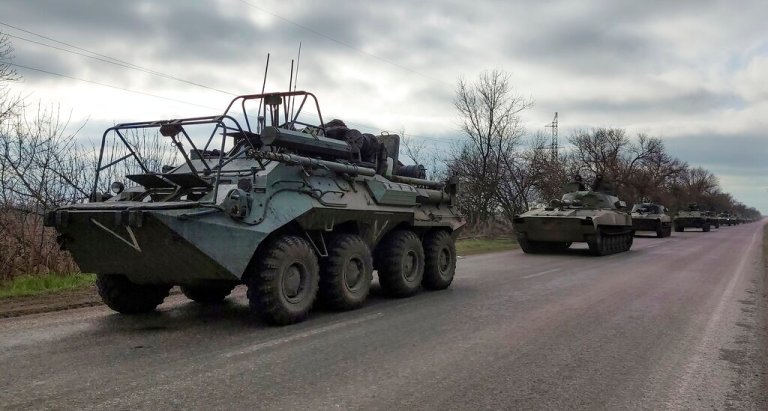 FILE - A Russian military convoy moves on a highway in an area controlled by Russian-backed separatist forces near Mariupol, Ukraine, on April 16, 2022.