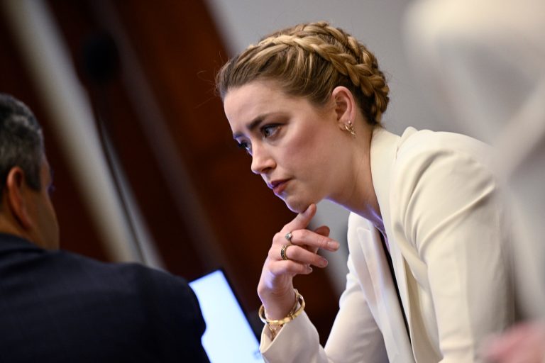 Actress Amber Heard talks to her attorney as she arrives in the courtroom at the Fairfax County Circuit Court in Fairfax, Va., Tuesday, April 26, 2022. Actor Johnny Depp sued his ex-wife actress Amber Heard for libel in Fairfax County Circuit Court after she wrote an op-ed piece in The Washington Post in 2018 referring to herself as a "public figure representing domestic abuse." 