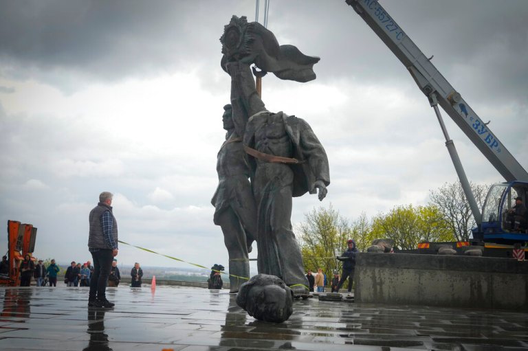 A Soviet era monument to a friendship between Ukrainian and Russian nations is seen during its demolition, amid Russia's invasion of Ukraine, in central Kyiv, Ukraine, Tuesday, April 26, 2022.