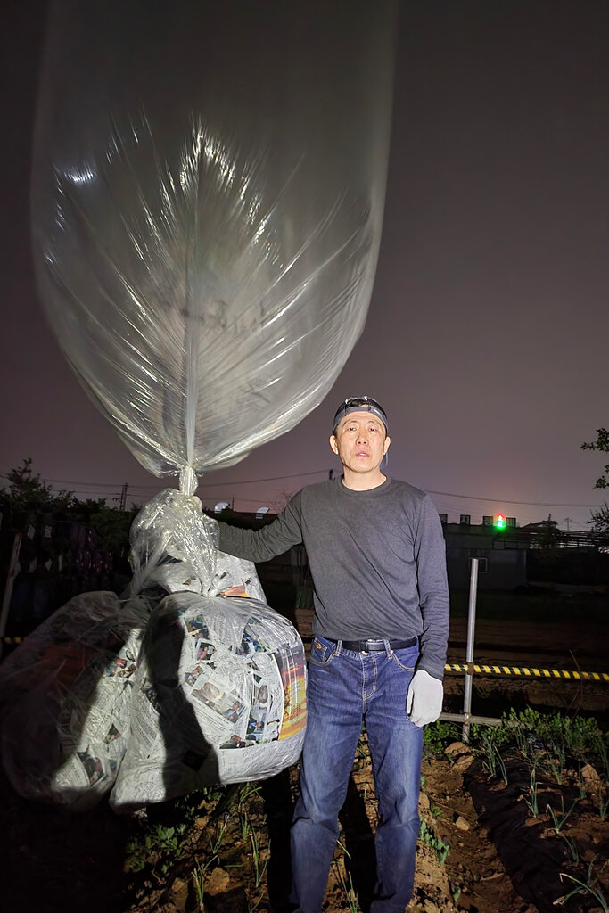 Park Sang-hak, a North Korean defector-turned-activist, prepares to release a balloon bearing leaflets at the border town of Gimpo, South Korea, on April 25-26, 2022. The South Korean activist said Thursday, April 28, he launched a million propaganda leaflets by balloon into North Korea this week, in his first such campaign while standing trial for past leafleting under a contentious new law that criminalizes such actions.
