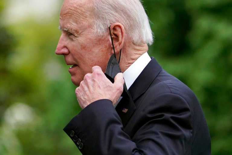 President Joe Biden pictured removing his mask as he walks on the South Lawn of the White House on May 1, 2022. (AP Photo/Patrick Semansky)