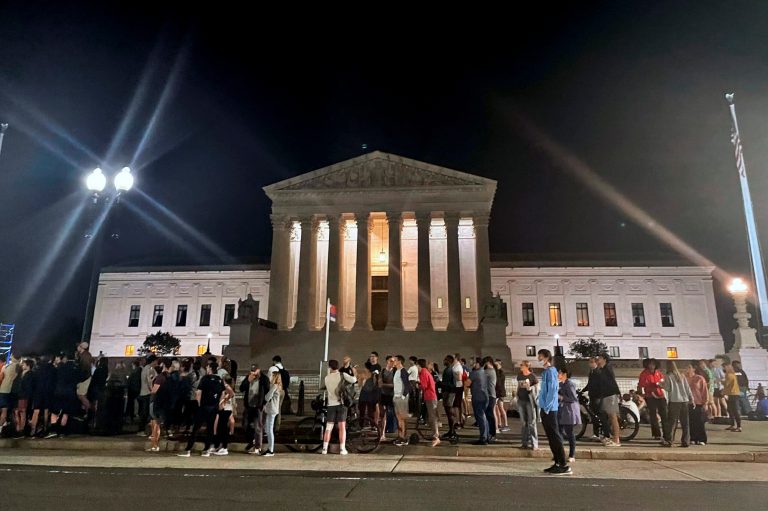 A crowd of people gather outside the Supreme Court, Monday night, May 2, 2002 in Washington. (AP Photo/Anna Johnson)