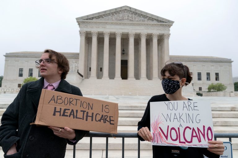 Demonstrators protest outside of the U.S. Supreme Court early Tuesday, May 3, 2022, in Washington.